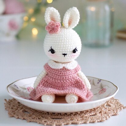 Little bunny toy in light pink dress with the flower on the ear