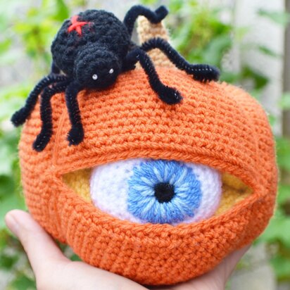 Crochet pumpkin. One-eyed pumpkin. Red cross spider. Halloween decoration. Pumpkin amigurumi