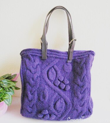 Purple bag with bobbles and cables