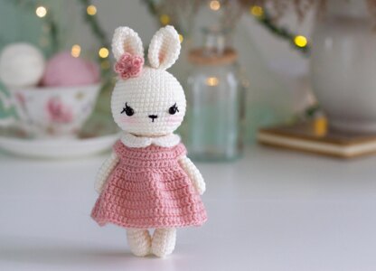 Little bunny toy in light pink dress with the flower on the ear