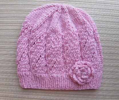 Pink Hat with Eyelet Panels and a Knit Rose for a Lady
