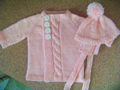 Center cable baby cardigan and pompom hat with ear flaps