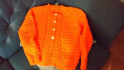 Mia ' s orange cardigan