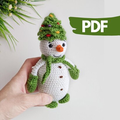 Crochet snowman in a Christmas tree hat amigurumi pattern
