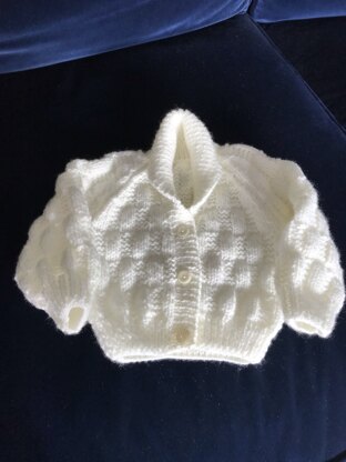 Patterned cream cardigan and hat