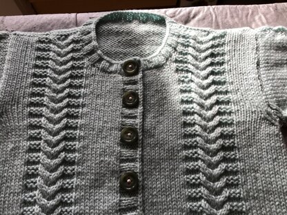 A second little girl’s cardigan with t-bag hat