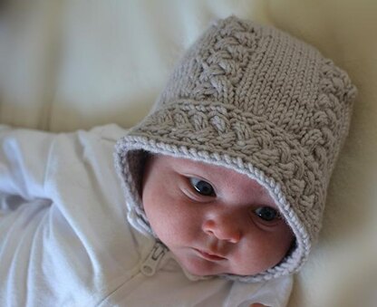 Cable Baby Bonnet Knitting pattern by Lara Simonson | LoveCrafts