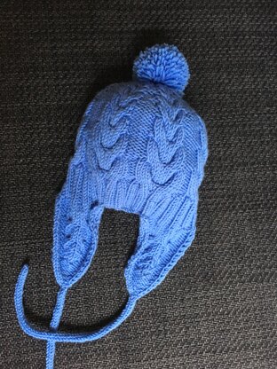 Ear flap cabled beanie with icords