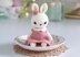 Little bunny toy in light pink dress with the flower on the ear