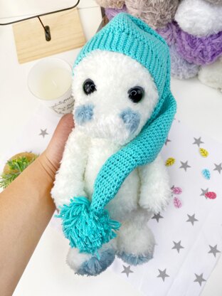 Cute stuffed dinosaur in a beanie