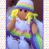 Doll knitting pattern with rainbow outfit.