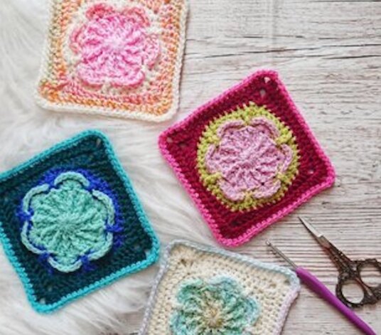 four different granny squares laid out on a table