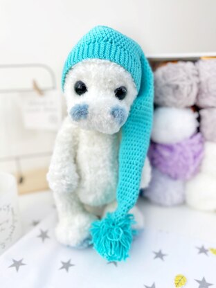 Cute stuffed dinosaur in a beanie