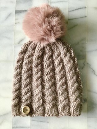 Cabled beanie with faux fur pompom