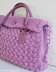 Textured bag knitted with woven pattern