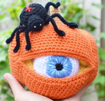 Crochet pumpkin. One-eyed pumpkin. Red cross spider. Halloween decoration. Pumpkin amigurumi