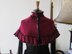 Victorian-style ruffled cape