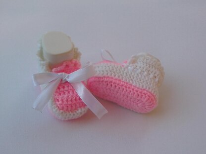 Pink and white baby shoes