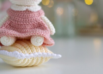 Little bunny toy in light pink dress with the flower on the ear