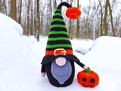 Halloween black gnome with pumpkin