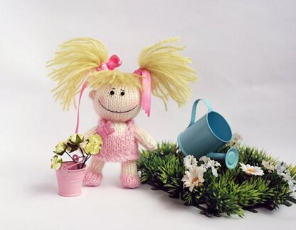 Small funny gardener Doll in the pink dress