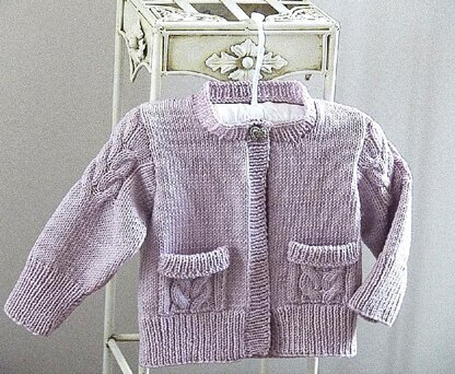 Child’s Cardigan with cable detail on sleeves and pockets - P065