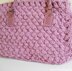 Textured bag knitted with woven pattern