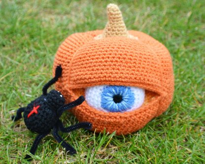 Crochet pumpkin. One-eyed pumpkin. Red cross spider. Halloween decoration. Pumpkin amigurumi