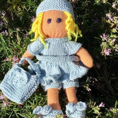 Doll knitted pattern with blue outfit