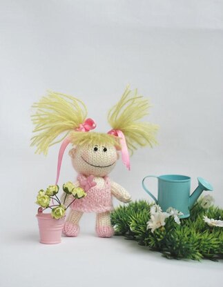 Small funny gardener Doll in the pink dress