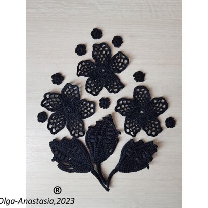 Crochet composition of flowers and leaves in black