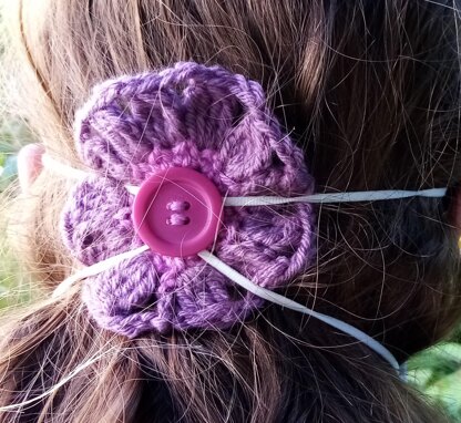 Crochet flower to hold facemask in place