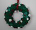 Knitted Christmas wreath with holly leaves, berries and snowballs