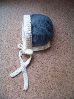 Blue baby bonnet with white trim