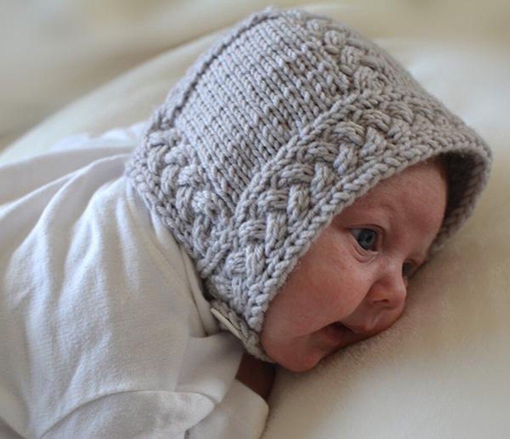 Cable Baby Bonnet Knitting pattern by Lara Simonson | LoveCrafts