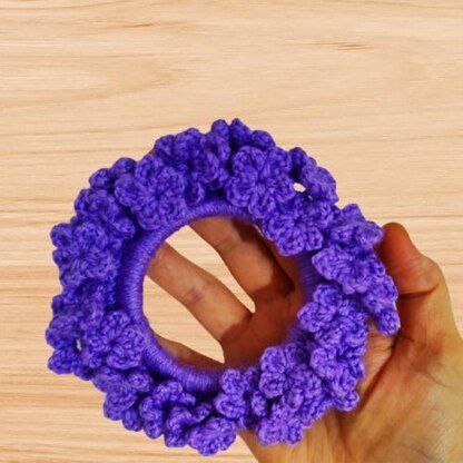 A crochet flower scrunchie