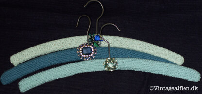 Knitted hanger covers with vintage broochs