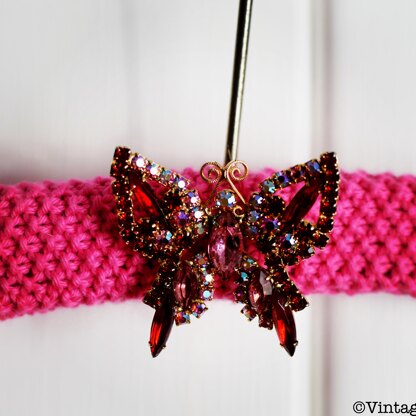 Knitted hangers with a butterfly brooch