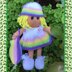 Doll knitting pattern with rainbow outfit.