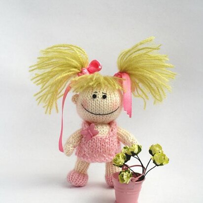 Small funny gardener Doll in the pink dress