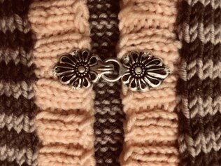 Baby cardie with metal clasp