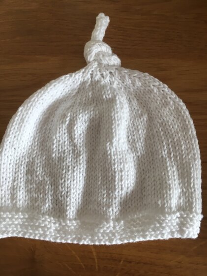 Tegan baby hat with top knot