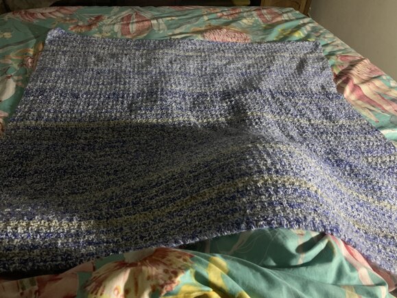 Crocheted seed stitch blanket with a twist